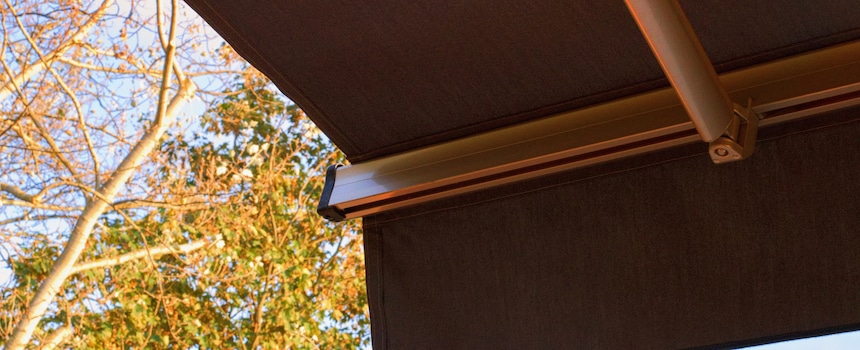20 Deck Awning Ideas Perfect for Patio Season Retractable patio awning with trees in background