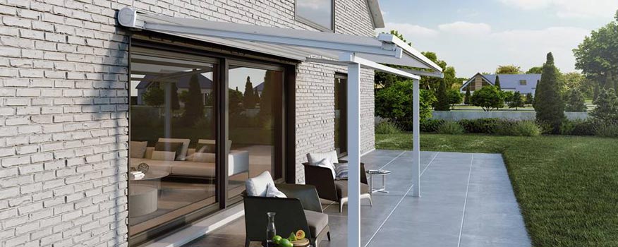 A modern patio featuring a sleek awning, offering shade and comfort while overlooking a lush garden. This inviting outdoor space embodies the idea of giving thanks for the comforts of home, blending relaxation with natural beauty.