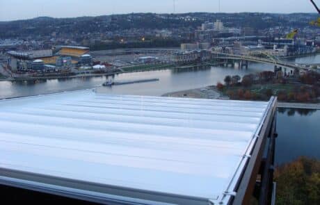 Cityscape view with river, stadium, and rooftop