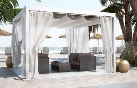 Beachside cabana with seating and ocean view.