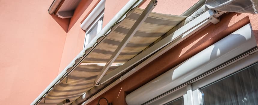 Projection vs. Width The Two Numbers That Make or Break Your Awning Retractable awning on sunny house exterior -Projection vs. Width The Two Numbers That Make or Break Your Awning