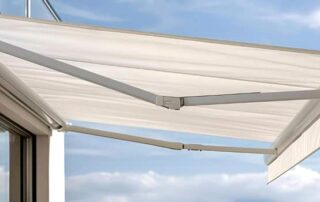 Retractable patio awning under blue sky