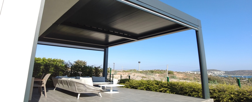 The Colorado Outdoor-Living Boom Modern patio with pergola and countryside view.