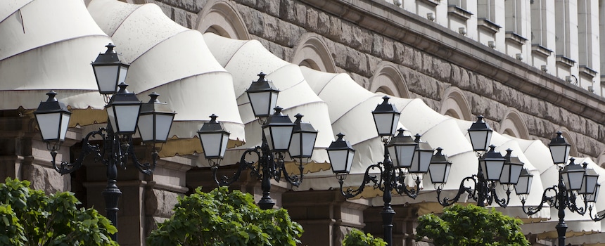 Tips for Keeping Your Outdoor Awning Looking Great Ornate street lamps beneath white building awnings