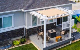 A beautiful backyard deck featuring a pergola providing shade over a cozy outdoor furniture setup, creating a relaxing and functional outdoor space. This image showcases one of the many outdoor shade options for homes, enhancing both comfort and aesthetics.